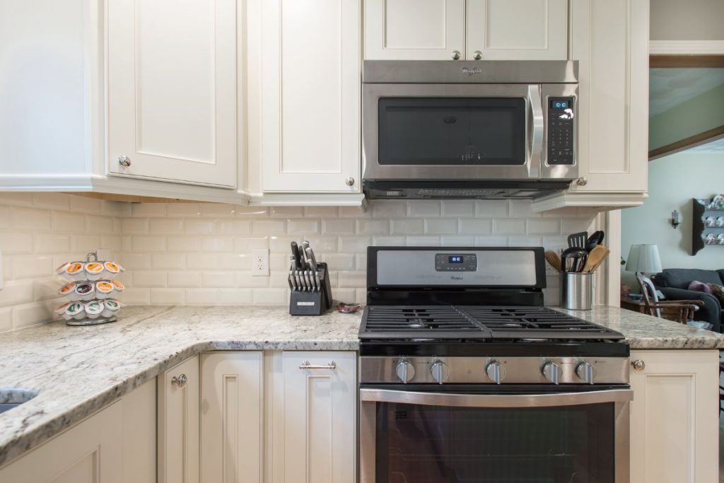 Stainless steel microwave and range in Okemos kitchen remodel