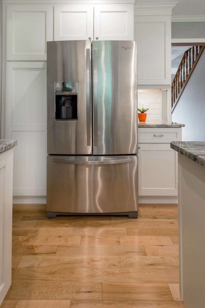 Hardwood floors and stainless steel refrigerator
