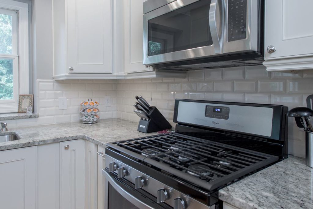 White cabinets with stainless steel gas range