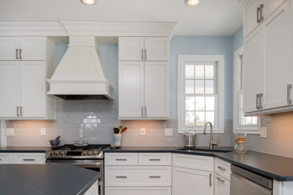 White kitchen cabinets with undercabinet lighting