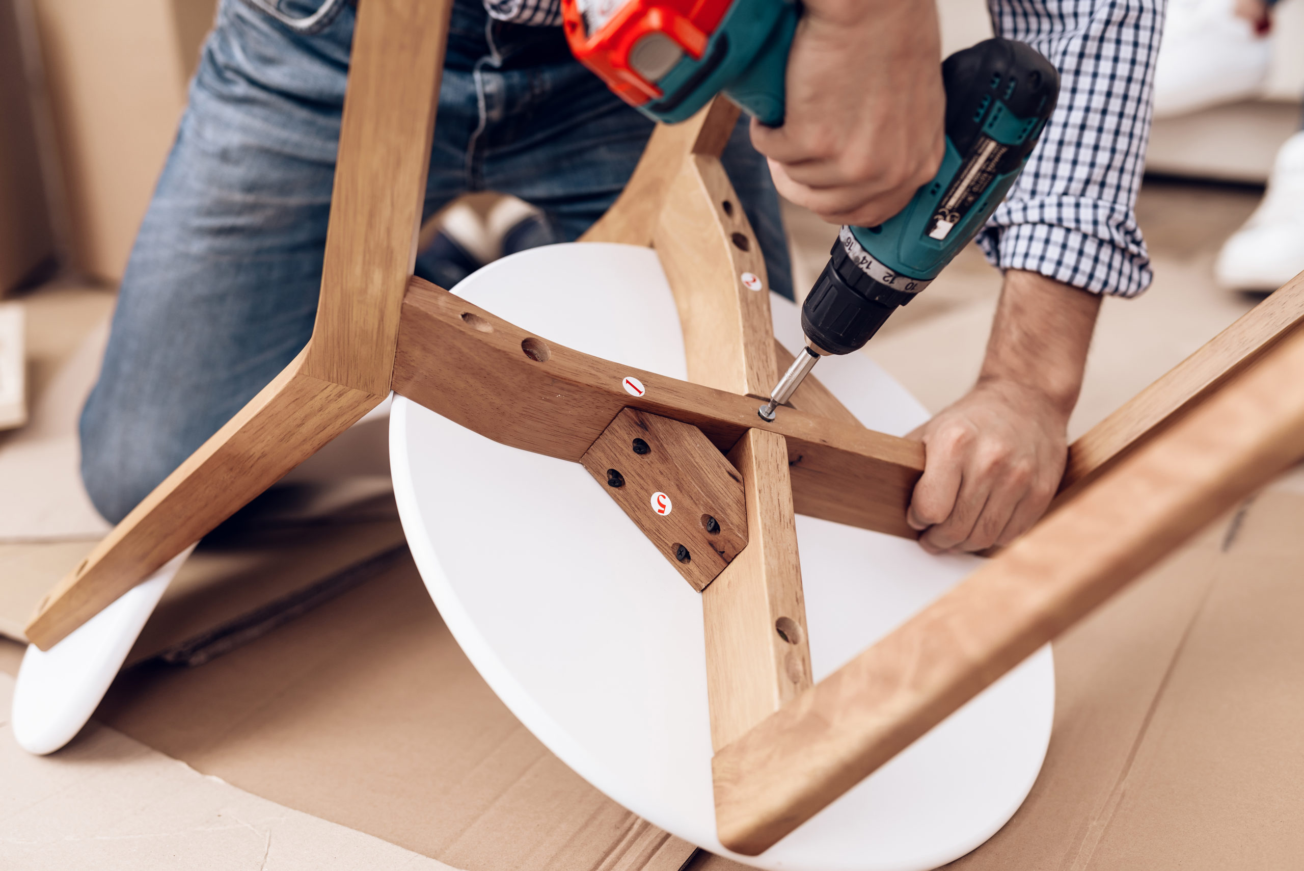 The man handyman is engaged in assembling the chair. The repairman is engaged in mending the chair.