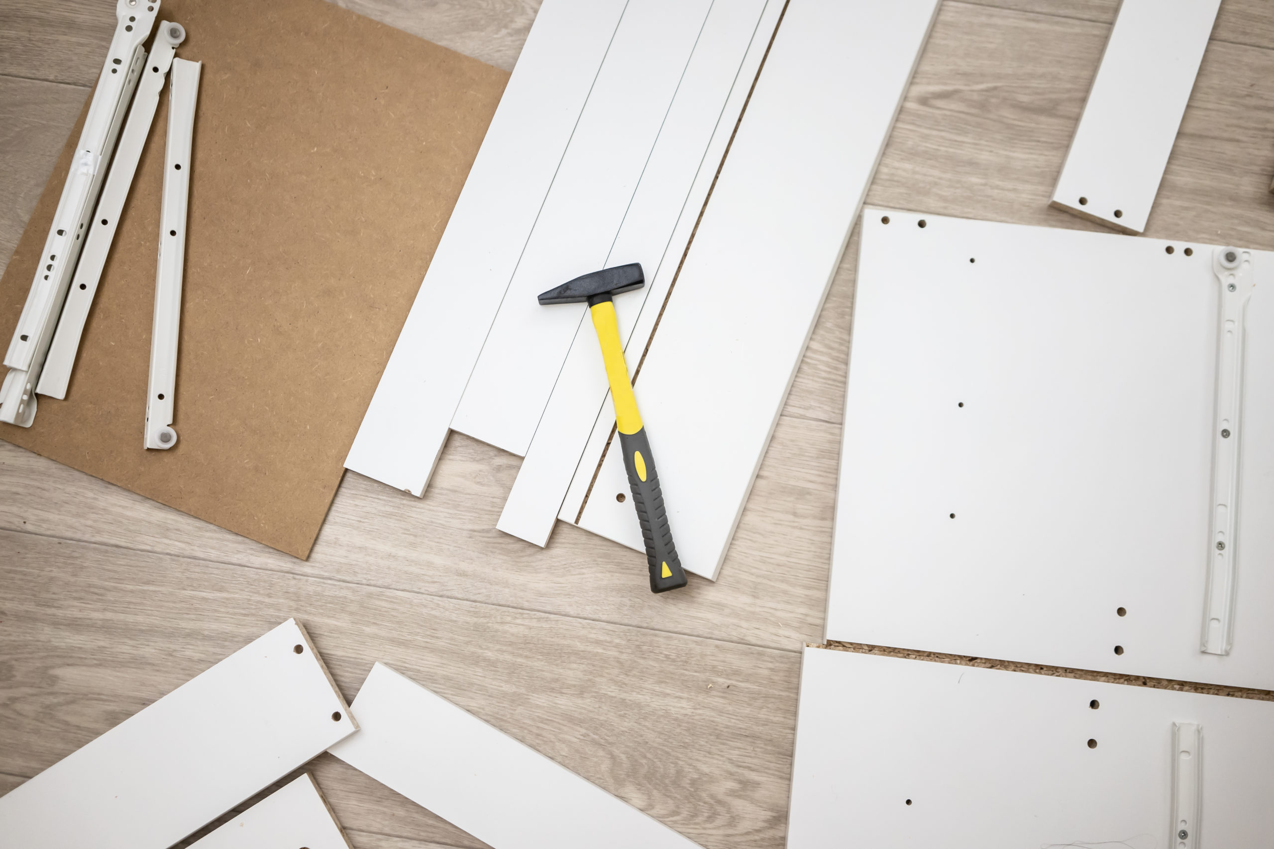 Furniture assembly parts and tools for self assembly furniture, on the floor. instructions for furniture assembling with tools Furniture assembly parts and tools for self assembly furniture, on the floor. instructions for furniture assembling with tools.